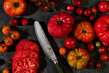 Tomatoes surrounding a 5" HexClad Bread Knife
