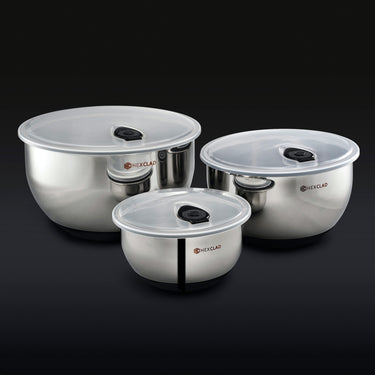 3 HexClad stainless steel mixing bowls with vacuum seal lids on a black background.