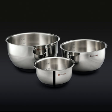 3 HexClad stainless steel mixing bowls on a black background.