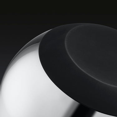 A closeup of the underside of a HexClad stainless steel mixing bowl.