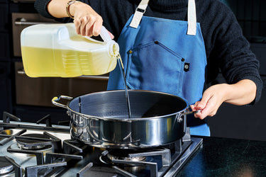 Oil being poured into a HexClad 7QT Chicken Fryer
