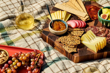 large HexClad hexagonal charcuterie board with cheese, crackers and grapes