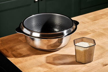 HexClad Rice Pot next to a HexClad Go Cup filled with rice