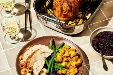 Stuffing Butter-Roasted Turkey Breast with Crispy Cornbread & Cipollini plated in front of the Hybrid Small Roaster