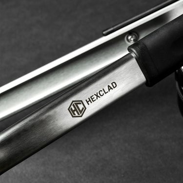 A closeup of the HexClad logo on a pair of tongs.	