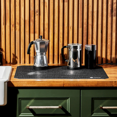 A coffee maker drying on a HexClad Dish Drying Mat.