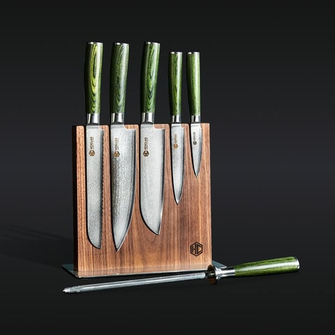 Knife set with green handles in a wooden block with sharpening steel.