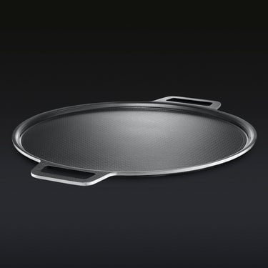 HexClad hybrid pizza steel on a black background