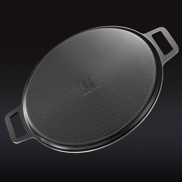 The underside of the HexClad hybrid pizza steel on a black background