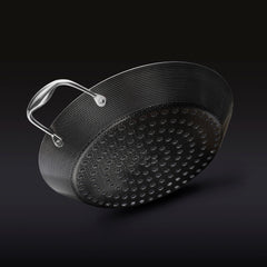 The underside of the HexClad 12&quot Hybrid BBQ Grill Pan on a black background