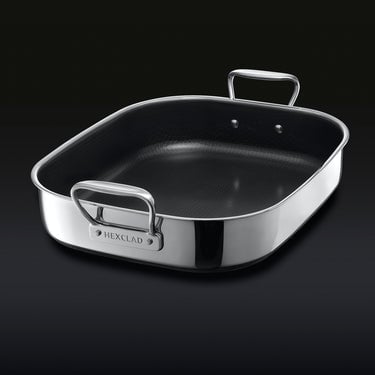 The HexClad Hybrid Roasting Pan on a black backround, shown from a diagonal viewpoint.