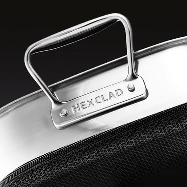 A closeup of the stainless steel HexClad branded handle of the HexClad Hybrid Roasting Pan.