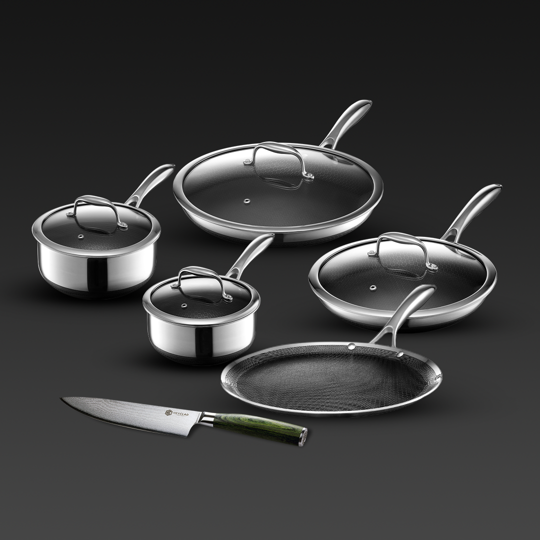 Array of HexClad cookware featuring two saucepans with lids (2 qt and 3 qt), two frying pans, and a chef's knife with a green handle, all set against a dark grey background, highlighting the sleek design and professional quality of the set.