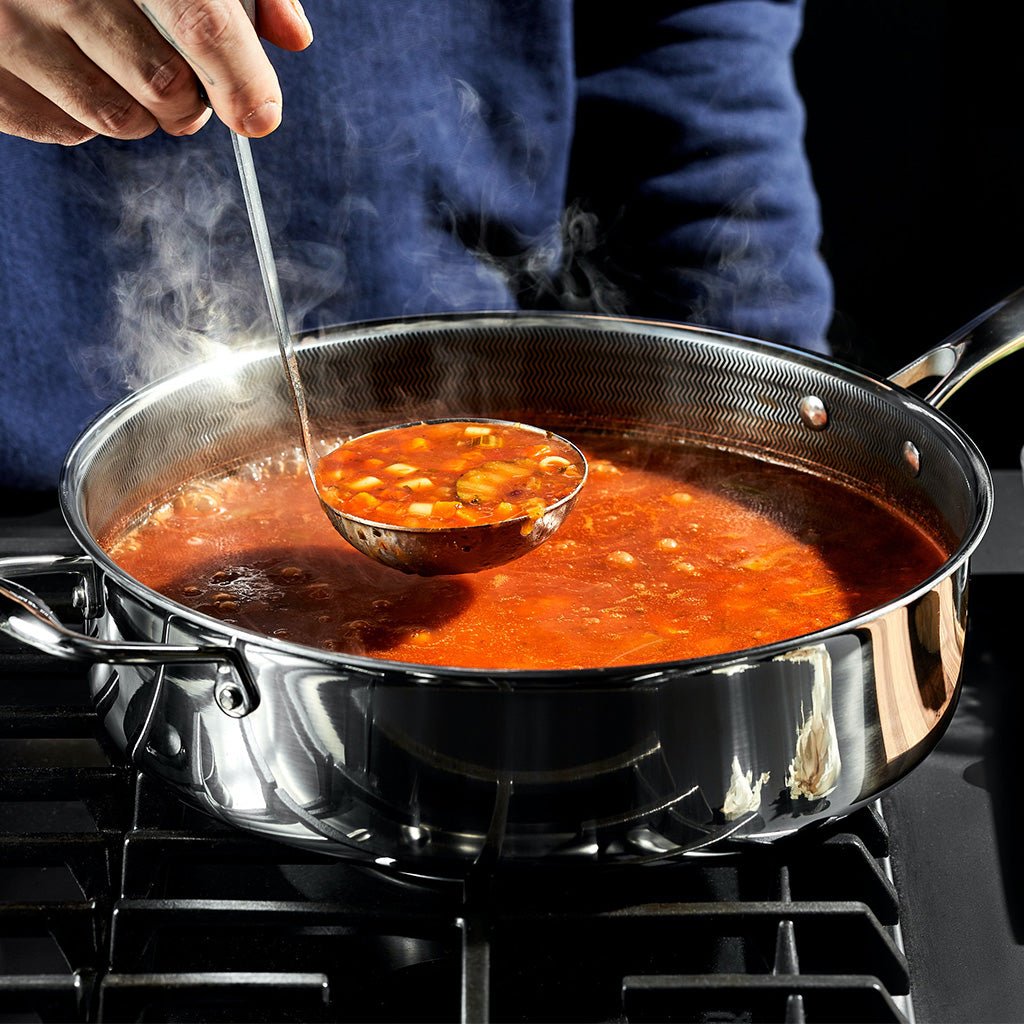 soup ladle dipping hot soup from an 8 quart pot