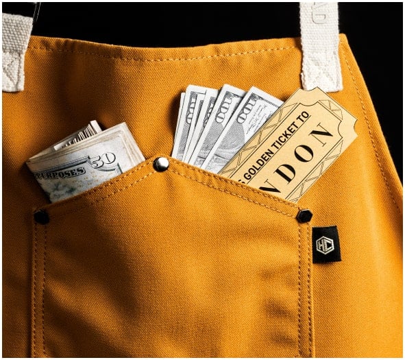 A yellow pocket holding cash and a golden ticket to London.