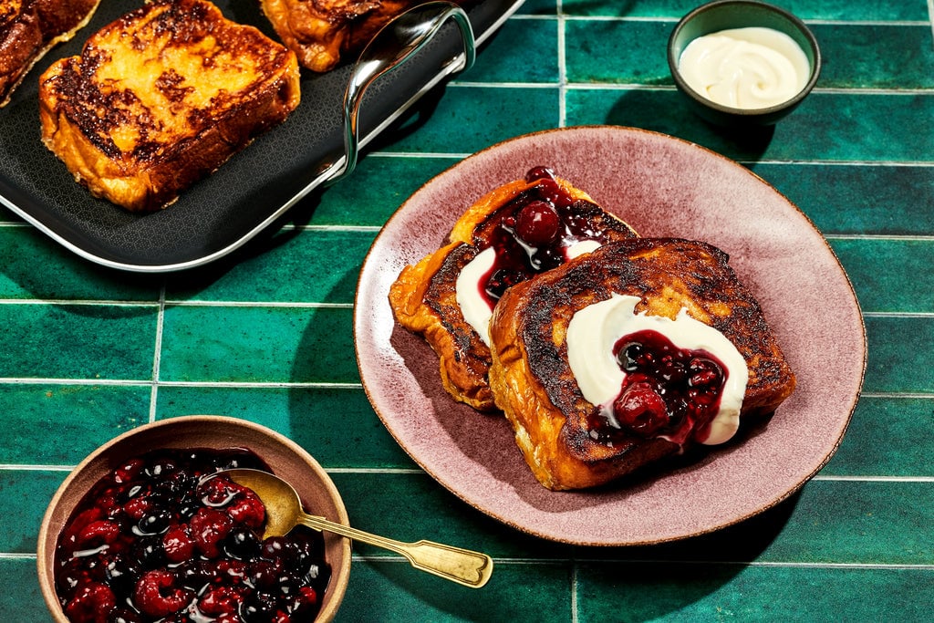 Caramelized French Toast with Berry Compote on green background