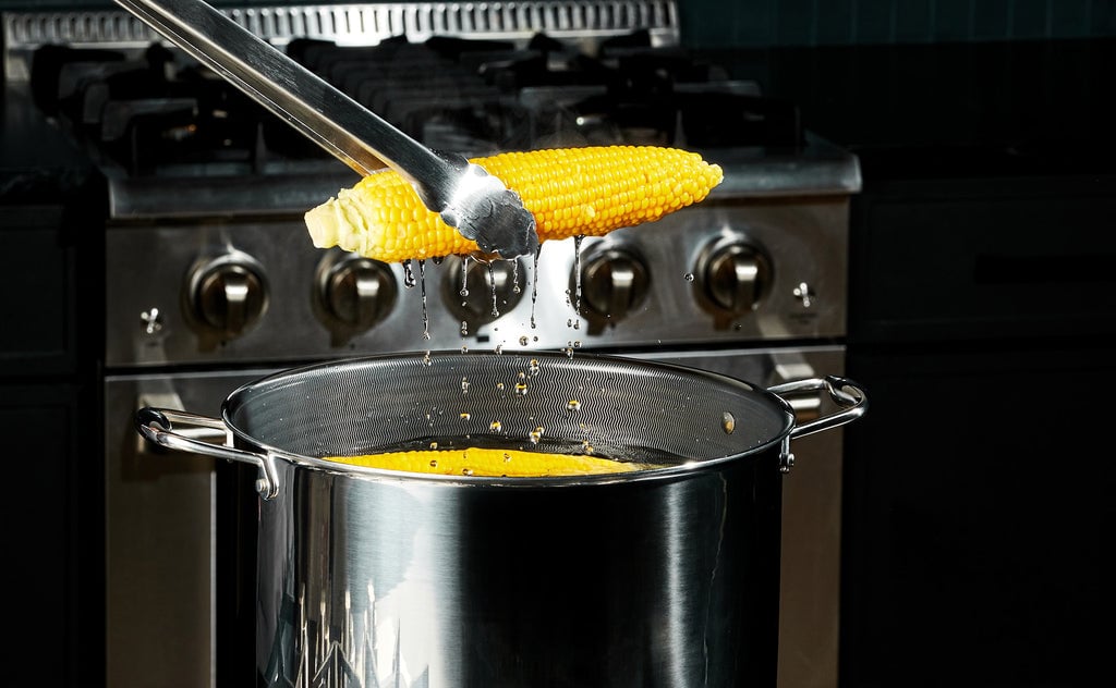 Corn being pulled out of a HexClad 12 QT Stock Pot