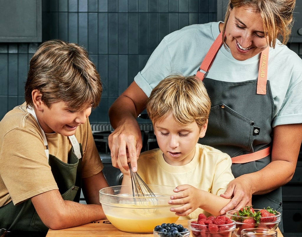 Mom and kids whisking eggs in a bowl
