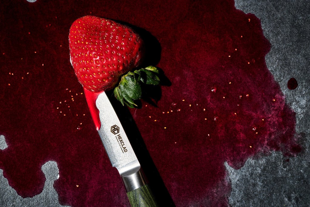 Juicy strawberry being cut into by a HexClad Paring Knife