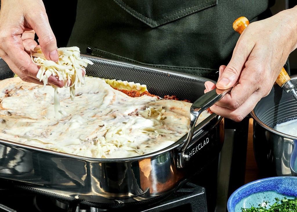 Cheese being layered onto the Ultimate Lasagna