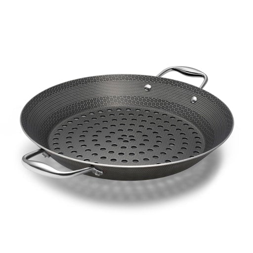 A round, perforated, black grill pan with two handles on a white background.