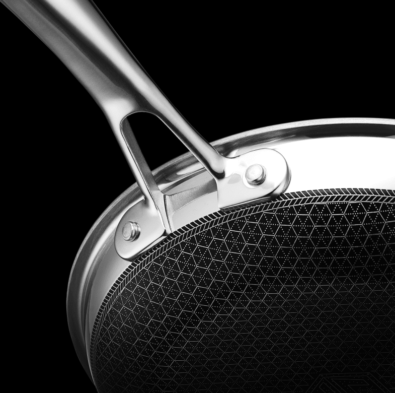 Close-up of a stainless steel frying pan with a textured bottom and a smooth handle.