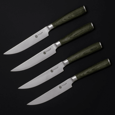 Four kitchen knives with green handles arranged horizontally on a black background.