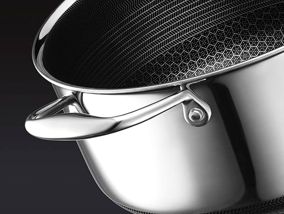 Close-up of a stainless steel pot with a hexagonal pattern interior.