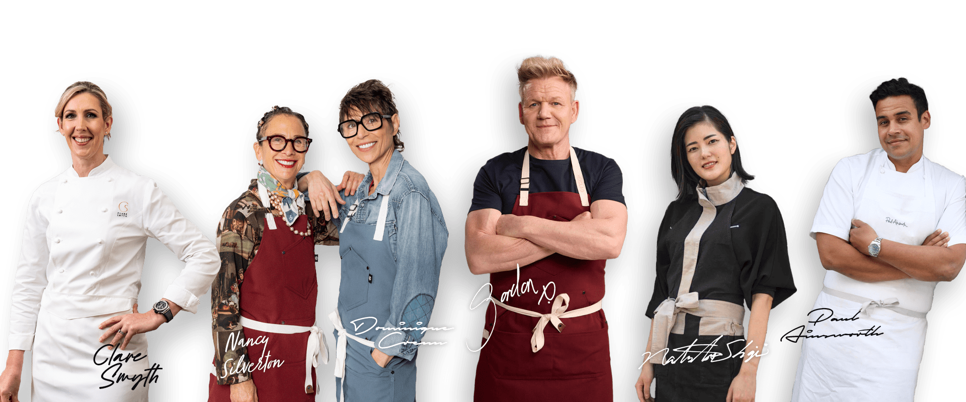 Group of chefs wearing aprons, smiling confidently.