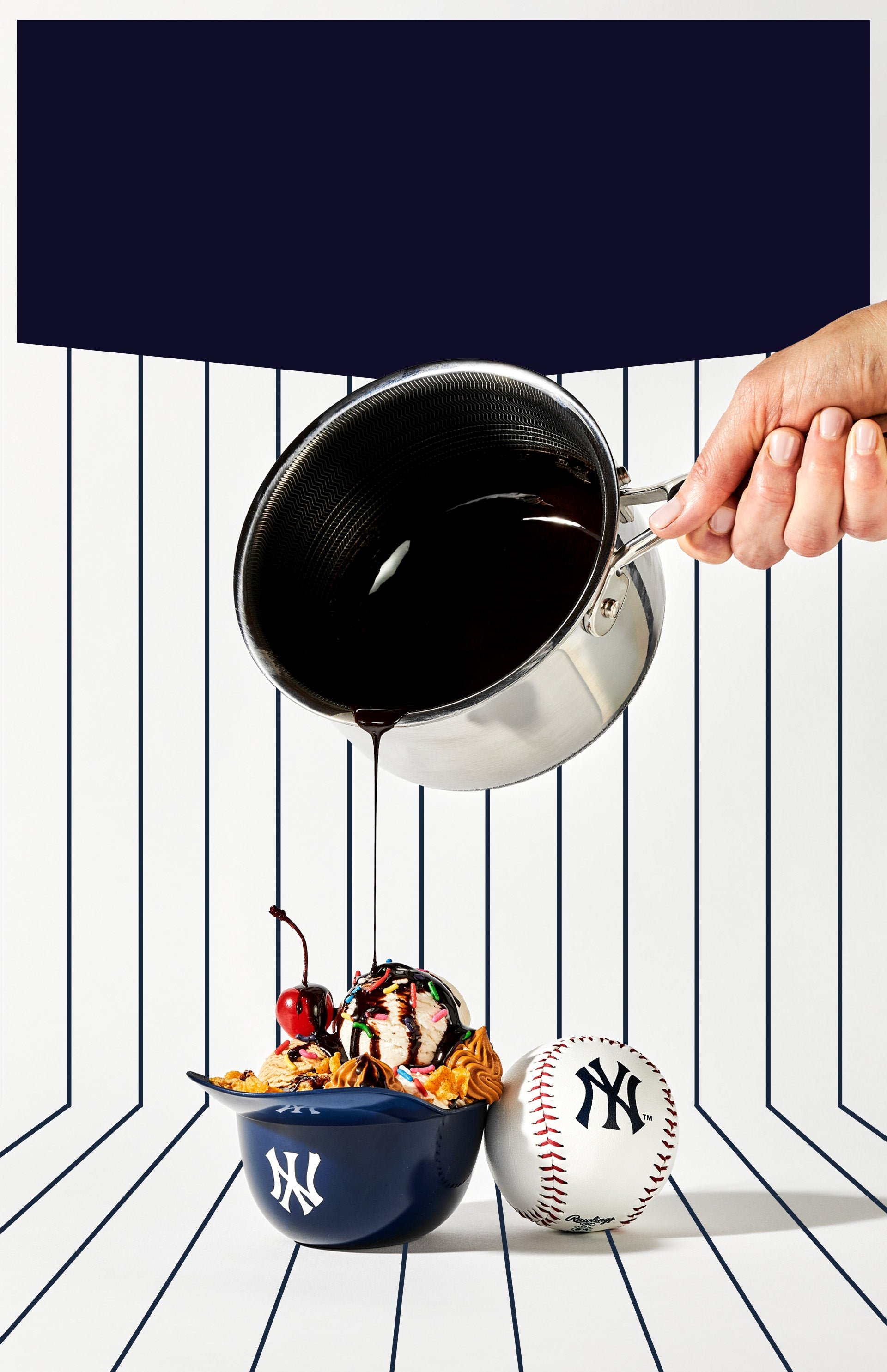 Hand pouring chocolate syrup on a sundae in a baseball cap bowl, next to a baseball.